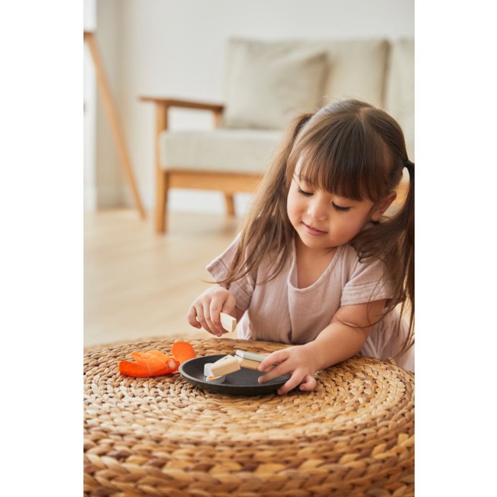 Kid playing PlanToys Seafood Platter เด็กกำลังเล่นชุดอาหารทะเลแปลนทอยส์